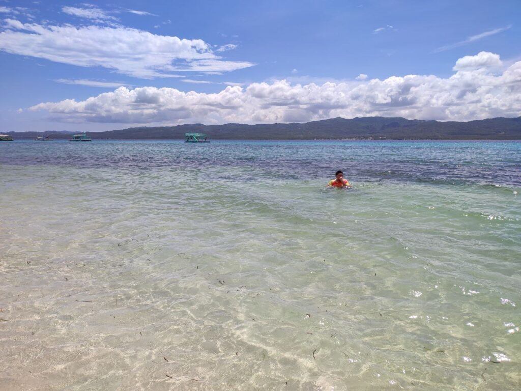 A man swimming by the sea of Alibijaban Island